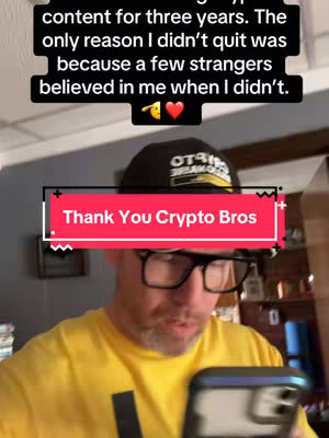 A man with glasses and a yellow shirt is holding a phone, appearing to record a video. The overlay at the top of the screen contains gratitude text. The background provides subtle glimpses of a room.