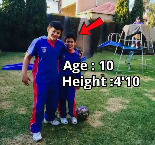 Two pre-teen boys in matching blue and red tracksuits pose for a photo in a backyard. Text overlays indicate their age and height. Behind them, a grassy area leads to a play structure and trees.