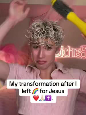 A person with blonde, curly hair is shown from the chest up, facing the camera with a distressed expression. Their hands are raised, and a yellow round brush is near the head. The background is a pink-lit room with a neon sign.