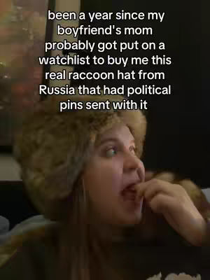 A woman with a questioning expression is wearing a fur hat and looking to her right. Text overlays the image.