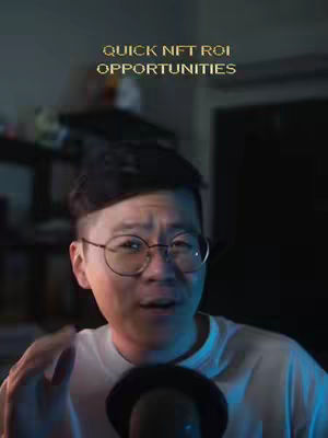 A man with glasses is visible from the chest up, partially behind a microphone. The background is dark and blurred, and text overlays the top of the image.