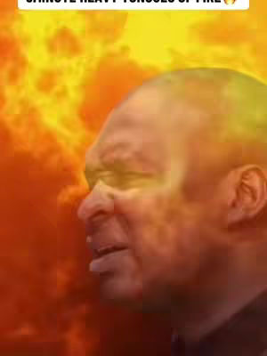 A medium shot features a man's face with an overlay of flames, set against a fiery background. The man is seen from the side, looking slightly upwards with a focused expression. The background is dominated by bright orange and yellow flames, creating a sense of intensity and energy.
