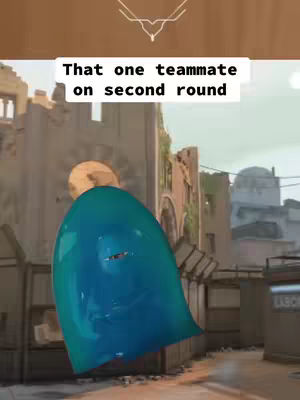 An image featuring a character in a Valorant scene. A figure is wearing a large blue, blob-like costume with a small opening. The background shows a partially destroyed building, suggesting a war-torn environment. Text overlayed in the image reads 'That one teammate on second round'.