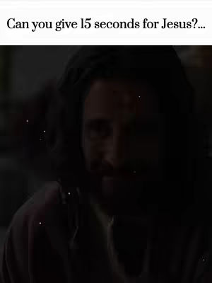 The image is a portrait of a man with dark hair and a beard, softly illuminated in a low-light setting. The upper portion of the image contains text, with the man's face slightly visible.