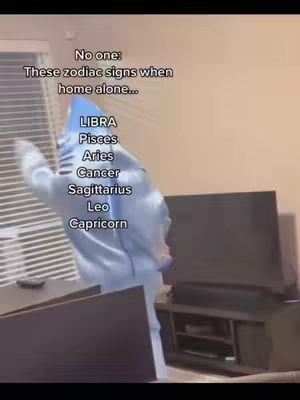 A person in a blue hoodie is dancing in front of a television set. Text overlaying the image says: 'No one: These zodiac signs when home alone...'. Then, there is a list of zodiac signs.