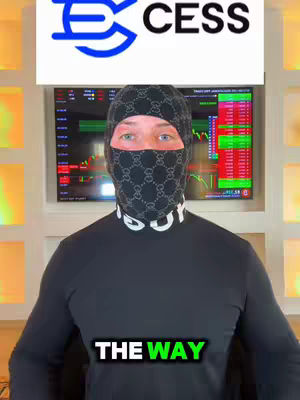 A man wearing a black balaclava with a Gucci-style logo. His upper body is in view, with a black long-sleeved shirt. Behind him is a TV screen displaying graphs and cryptocurrency data, and a white banner showing "CESS" and its logo.