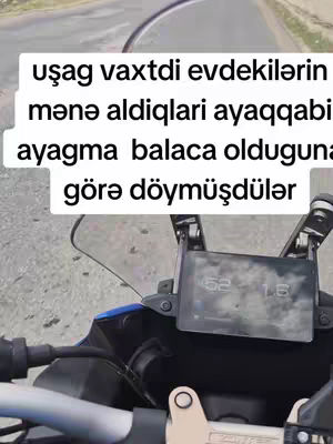 The cover image shows a first-person perspective, likely from a motorcycle. In the foreground is the motorcycle's dashboard, with a screen displaying information. Above this, a text overlay in a white box contains text in an unfamiliar language. The background shows a road and surrounding environment, suggesting movement.