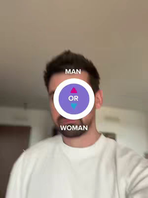 A selfie-style shot featuring a man in a white shirt against a blurred indoor background. A visual overlay covers the man's face with a white circle containing the word "OR" between two arrows pointing upwards and downwards, and the text "MAN" and "WOMAN" on top and bottom of the circle.