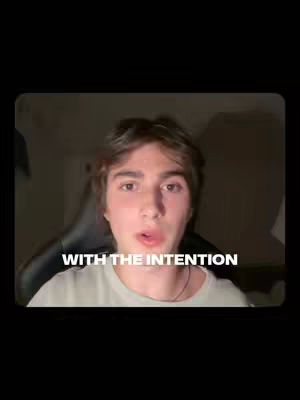A young man with brown hair and fair skin is centered in the frame, looking directly at the camera. He has a neutral expression. Below him, white text appears against a dark background. The composition focuses on the man's face with a simple background. The overall color scheme is dark, emphasizing the subject and text.