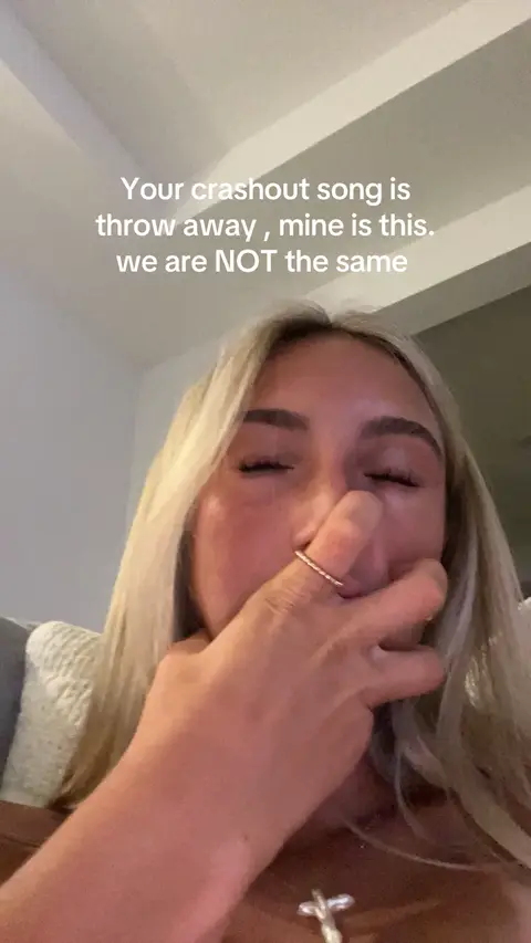 A close-up shot of a woman covering her mouth with her hand. She has blonde hair and is wearing a ring. Text overlays on the image.