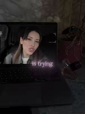 The cover image shows a woman on a laptop screen, with a text overlay reading "is trying." The image has a warm, somewhat desaturated color palette.