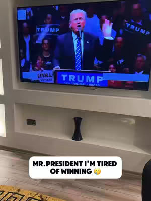 The cover image features a television screen displaying Donald Trump speaking at a podium, within a room setting. Below the screen is a white rectangular text overlay with the words 'MR. PRESIDENT I'M TIRED OF WINNING' and a yellow smiley face emoji.