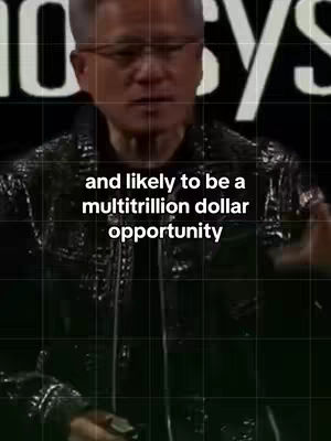 The image shows Nvidia CEO Jensen Huang in a close-up shot, speaking. The background appears to be a stage setting, with a dark backdrop and the word "BIO" or "BIOSYS" in large white letters behind him, partially obscured. Jensen is wearing glasses and a black jacket, and the text overlay is in white, centered near the bottom of the frame and reads, "and likely to be a multi-trillion dollar opportunity". The overall look is professional.