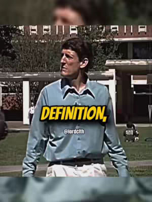 A man in a light blue shirt and white pants stands on the grass, looking off to the side. The text overlay says 'DEFINITION,'