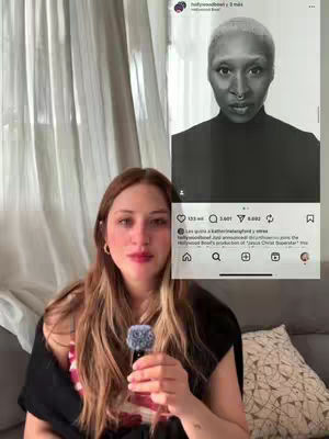 A young woman with long brown hair holds a small, fluffy blue object. In the background, behind the woman to her right, is a screenshot of an Instagram post featuring a black-and-white image of a person and some related text comments.