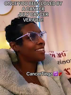 A woman with dark hair and glasses smiles into the camera while wearing a light-colored, fluffy robe. Text overlays the image on the top-left reading 'ONCE YOU BEEN LOVED BY A CANCER JULY CANCER VERIFIED!'. A logo for 'CancerTingz' is on the bottom right.