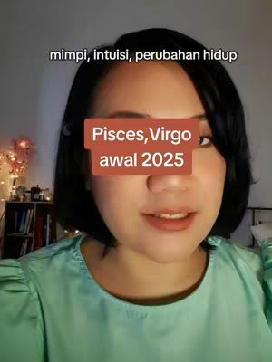 A woman with short, dark hair and a light-green top looks directly at the camera. The background is blurred, with hints of a bookshelf and fairy lights. A rectangular overlay covers most of her face displaying text.