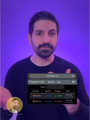A man with a beard and dark hair is centered in the frame. He wears a dark, long-sleeved shirt against a purple background. He holds a phone showing a cryptocurrency trading platform with a small profile picture in the corner, a bitcoin logo, and text overlay. He is smiling and looking at the camera.