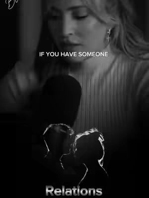 A black and white image featuring a woman in the upper portion with text overlayed near the top of the frame. Below the main subject, the silhouettes of two individuals are placed, and at the bottom a text is displayed.