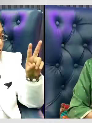 The image is a split composition featuring two sides. On the left, a person in a white suit with glasses extends their hand, displaying the peace sign with two fingers. The right side displays what seems to be the side of the person in a green outfit's body seated.