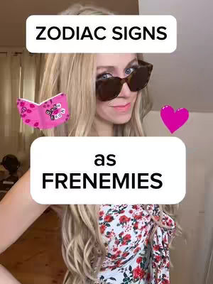 A selfie-style shot of a blonde woman wearing sunglasses. She is smiling, with a pink heart and a small book graphic. The background is slightly blurred, likely a domestic setting, with text overlays.