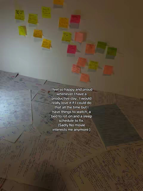 An image showcasing a wall covered in scattered colorful sticky notes and a stack of papers or books, suggesting a study or work environment. A handwritten text snippet is included.