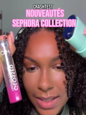 A close-up shot features a woman with dark, curly hair and brown skin holding two makeup products near her face. The text overlay reads the video title.