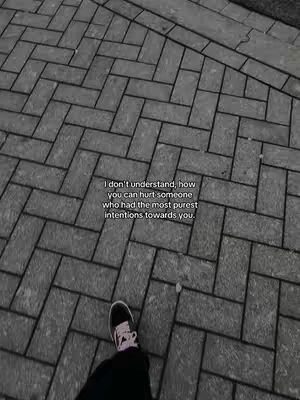 The image showcases a ground-level perspective of gray brickwork, with a person's foot in dark pants and a black shoe with a white and pink design. A white text is overlaid on the image, the composition is simple and slightly angled.