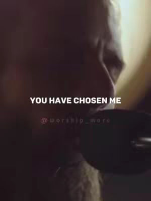 The cover image features a close-up of a person, partially obscured by shadows. The primary focus is on the person's face and upper body. The lighting is dim, and the color palette appears muted, with a focus on dark tones, possibly suggesting a serious or introspective mood. Text elements 'YOU HAVE CHOSEN ME' and '@worship_more' are overlaid on the image in white font.