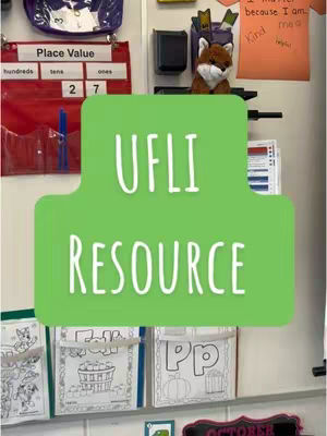 The image is a classroom scene, filled with educational resources. A green, irregular-shaped overlay with white text that reads “UFLI RESOURCE” sits prominently in the center. Behind it, a variety of items are visible: a place value chart, student work in plastic pockets, a stuffed fox, and inspirational notes. The overall impression is of a well-organized and engaging learning environment.
