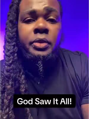 A close-up shot of a Black man with a serious expression, dark hair with braids cascading down one side, and a well-groomed beard. A text overlay reading 'God Saw It All!' is positioned at the bottom.