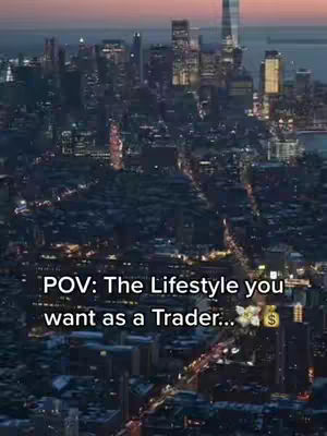 An aerial view of a city skyline at dusk. The city is densely packed with buildings, with lights illuminating streets and buildings, creating a grid-like pattern. The sky transitions from a deep blue to a softer, dusky pink. Text overlayed at the image's bottom stating "POV: The Lifestyle you want as a Trader..."