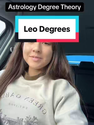 A woman is seated inside a car, facing the camera with a slight smile. The overhead text says "Astrology Degree Theory" and below this, a banner says "Leo Degrees". The woman's hair is long and brown, and she appears to be wearing a cream-colored sweatshirt and has a neutral expression, and in the background, we can see the interior of the car.