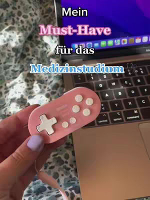 The cover image shows a hand holding a pink controller in front of a laptop. Text overlays the image, highlighting the content's focus on studying for medical school.