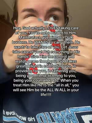 A person holds a mug with text while looking in the camera. The person is wearing a dark blue top and has text overlaid on the image.