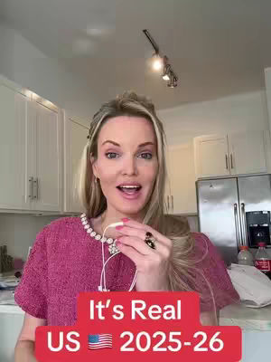 A woman with blonde hair and a pink top is speaking into a phone. She is in a kitchen. The overlaying text is displayed in a red box with white text that says 'It's Real US 2025-26'