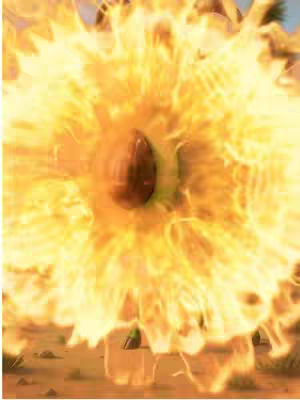 A vivid, surreal image dominated by a large, fiery explosion in the shape of a sunflower or a bursting star. At the center, an oval dark brown core possibly represents a seed or a central element, encircled by intense yellow and orange flames. The edges of the explosion radiate outward, creating an impression of energy and destruction. The background faintly hints at a desert or arid landscape. The composition is center-focused. The overall color palette is warm and bright, dominated by various shades of yellow and orange, with touches of brown and the slightest bit of green.