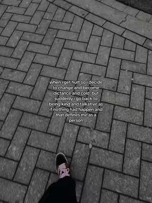 The image presents a grayscale perspective of a person's lower body and right foot, clad in a black outfit and sneakers. The textured surface, reminiscent of cobblestones, serves as a backdrop. Overlaying this is a block of text that describes an emotional journey of hurt, distancing, and eventual return to kindness.