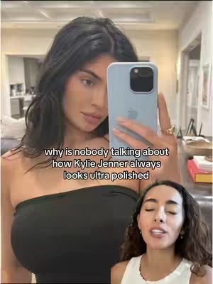 The cover image shows a split-screen effect. The top half features a woman in a black top, holding a phone in front of her face, taking a selfie. The bottom half shows a different woman speaking towards the camera. The caption reads "why is nobody talking about how Kylie Jenner always looks ultra polished".