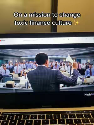 The cover image shows a scene from the movie 'The Wolf of Wall Street' where a man is addressing a crowd. The image is framed by a laptop, with the YouTube interface visible. Overlayed text at the top reads, 'On a mission to change toxic finance culture'.