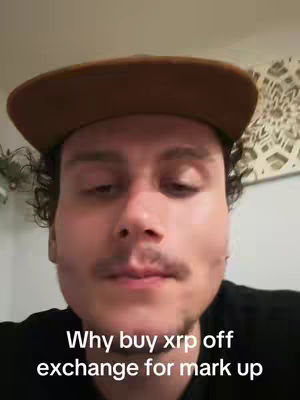 A close-up shot of a man with a brown baseball cap and curly hair in a room. The man has a mustache. Text is added at the bottom of the image.