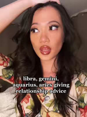 A woman with long, dark wavy hair looks towards the upper right with a surprised expression. The woman is wearing floral print top. Below the chin, text is overlaid on the image.