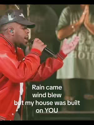 The cover shows a man holding a microphone and singing, his right arm outstretched, in front of a blurred background of people. Text overlay on the image reads a quote.