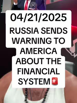The cover image features a split view presentation, possibly of a video. The upper section displays a man in a suit and tie, holding some item. The lower section presents a person wearing a white tank top. Overlaying this is a large rectangular box with the date and text: "04/21/2025", "RUSSIA SENDS WARNING TO AMERICA ABOUT THE FINANCIAL SYSTEM". The image uses a muted color palette with bold white text.