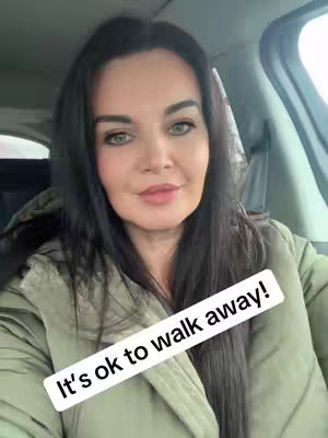 A woman with dark hair smiles in the front seat of a car. A text overlay offers a motivational message.
