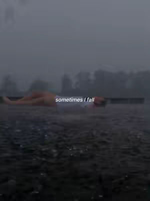 A person lying down outside in the rain, with the text "sometimes I fall" overlaid on the image.