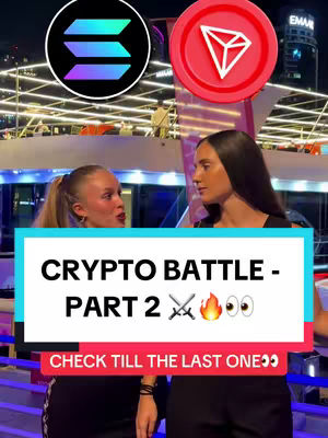 Two women face each other, possibly in a debate, with cryptocurrency logos above their heads. A text overlay reads 'CRYPTO BATTLE - PART 2'.
