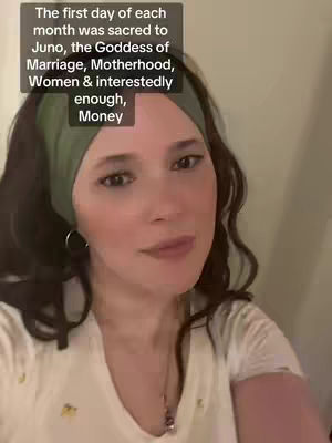 A woman with dark hair and a green headband looks directly at the camera. Text in a black box is displayed on the upper left corner.