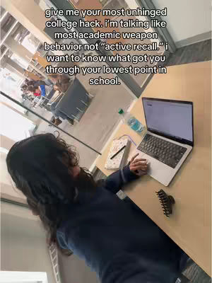 The image shows a person, presumably the creator, sitting at a table with a laptop, bottle of water and a notebook with a pen. Text overlayed on the image asks for college life hacks.