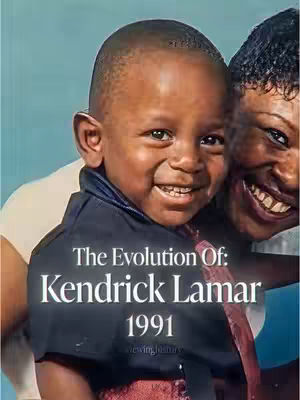 The cover image displays a close-up of a young boy, likely a child version of the subject, smiling directly at the viewer. The bottom half of another person's face (possibly a woman) is seen on the right, smiling as well. The boy wears a dark blue collared shirt over a lighter shirt. Text overlayed on the image reads "The Evolution Of: Kendrick Lamar 1991". The background has a light blue tone. The overall composition has a heartwarming feel due to the smiles and friendly expressions.